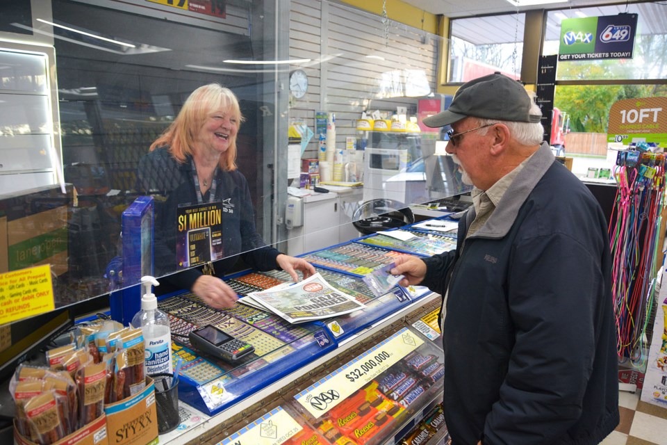 Darlene Sarvis shares a laugh with a customer at the Fonthill Avondale she has managed for 15 years.