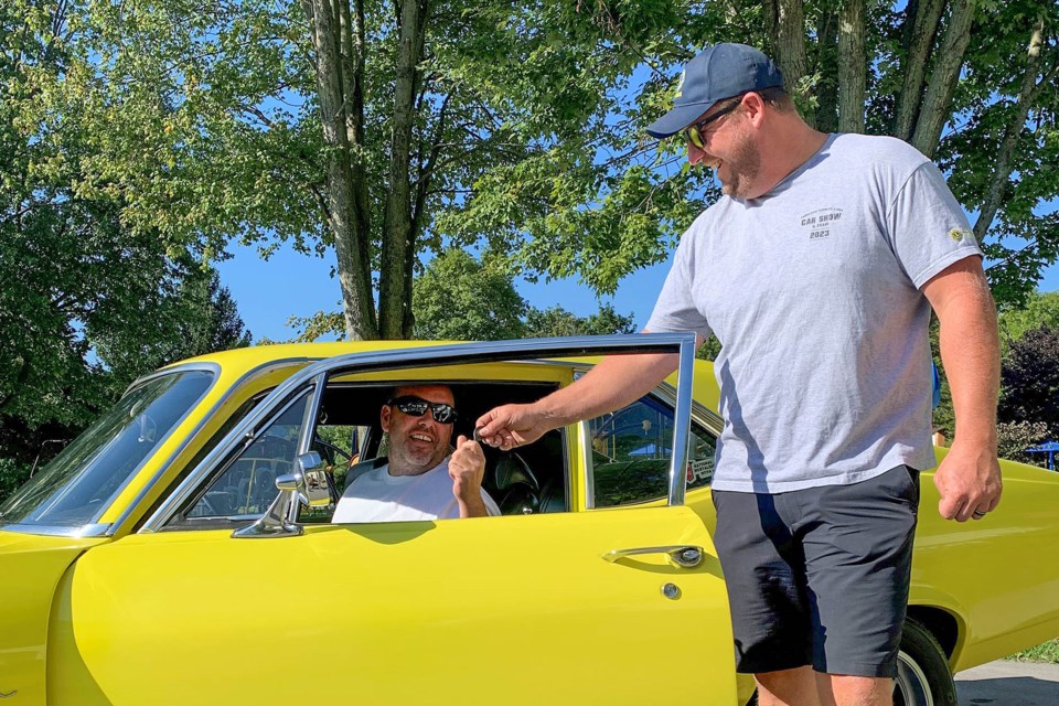 The Fabulous Fenwick Lions Club member Ryan Van Lochem gives the keys to a 1969 Chevy Nova SS to Corey Gauthier of Crystal Beach. Gauthier was the winner of the Club’s 2023 Classic Car Raffle.