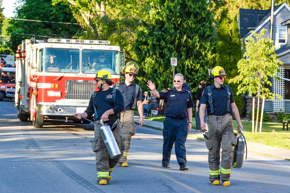 Pelham firefighters, with both modern and vintage equipment, lead the parade.