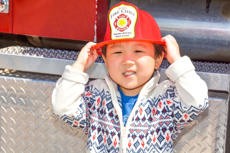 Leo tries on his fire chief hat.