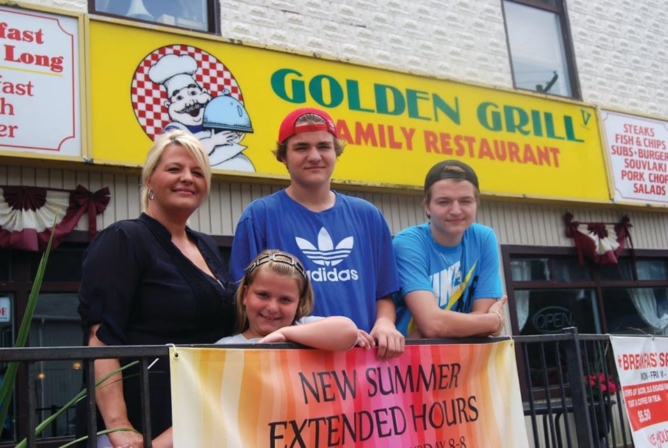 Lisa Kouretsos, her two sons and daughter in front of the family run restaurant Golden Grill.