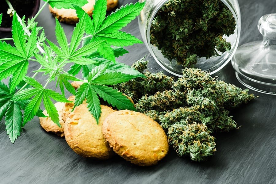 Cookies With Cannabis And Buds Of Marijuana On The Table And You