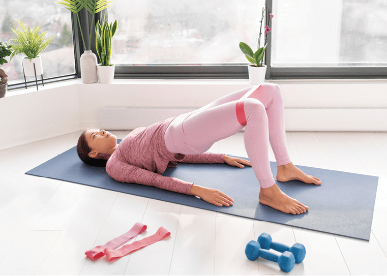 Woman Doing Resistance Band Seated Leg Extensions Exercise Stock