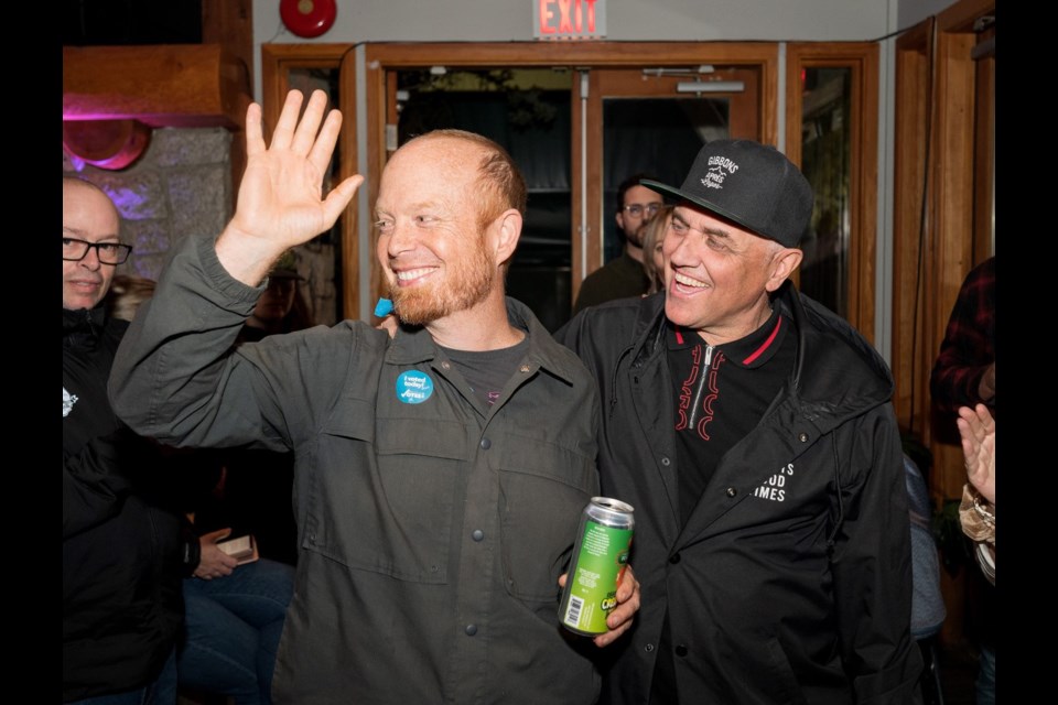 Mayor Jack Crompton, left, celebrates being re-elected as Whistler's top official at the Whistler Racket Club. 