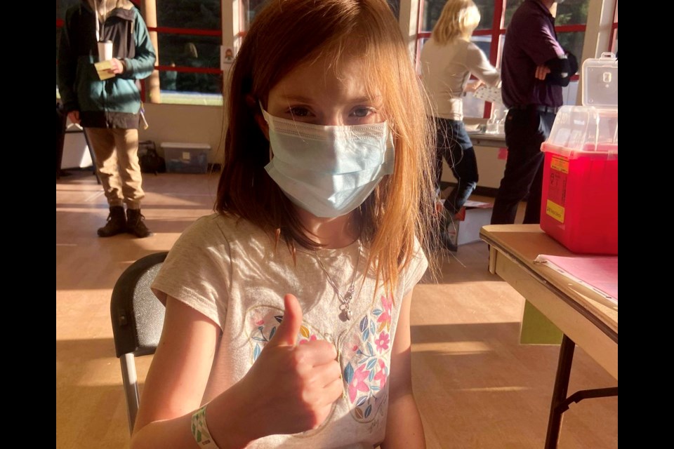 Eight-year-old Whistler resident Zadie Wilson smiles under her mask after receiving her first COVID-19 vaccine on Friday, Dec. 3. 