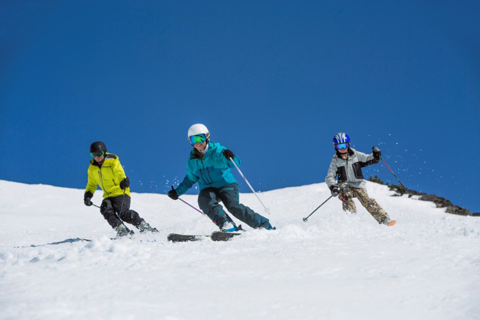 Whistler blackcomb ski instructor leads group on a sunny day