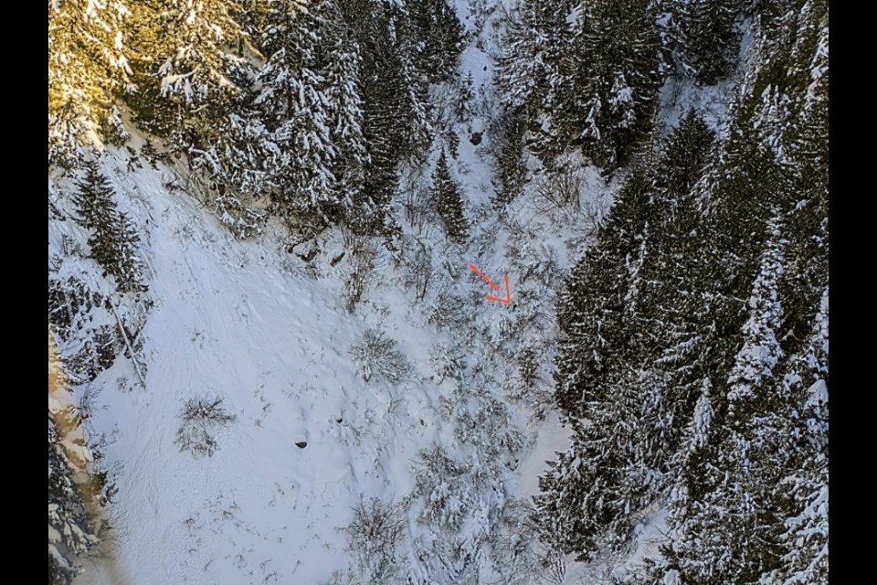 The red arrow points to a snowboarder who was rescued Sunday, Dec. 19, after getting lost on Whistler Mountain and spending two nights outdoors. The man’s dark clothing made him difficult to distinguish from the terrain from a helicopter, said Whistler Search and Rescue president Brad Sills.