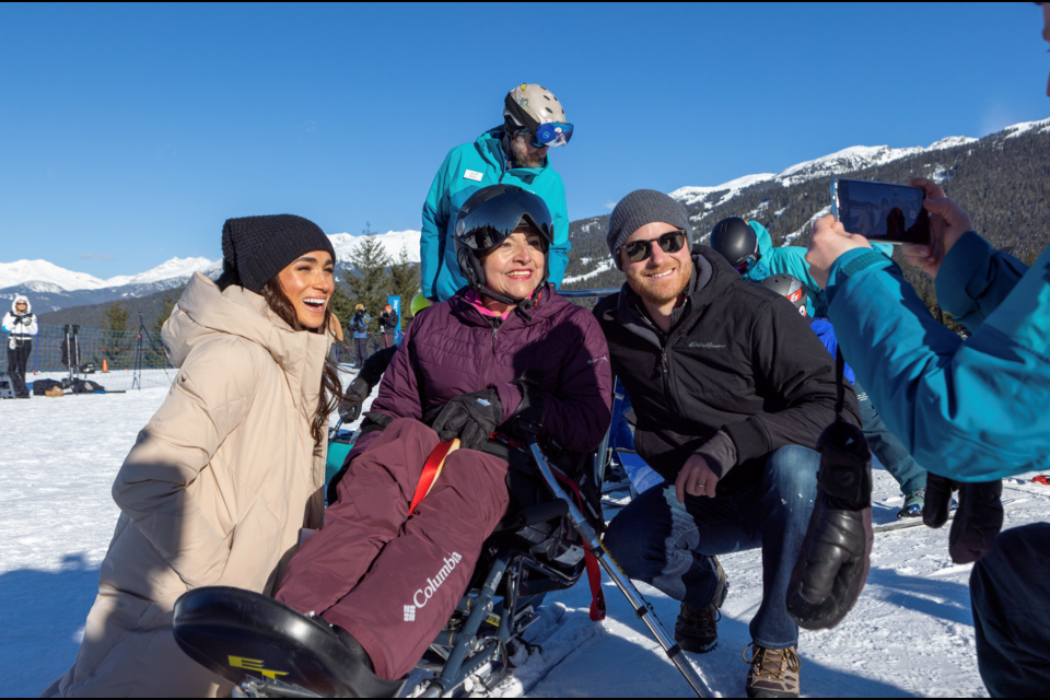 Meghan Markle and Prince Harry pose with Invictus participant Rosa Sanchez Bermudez from Colombia at a one-year-out celebration event in Whistler on Feb. 14.
