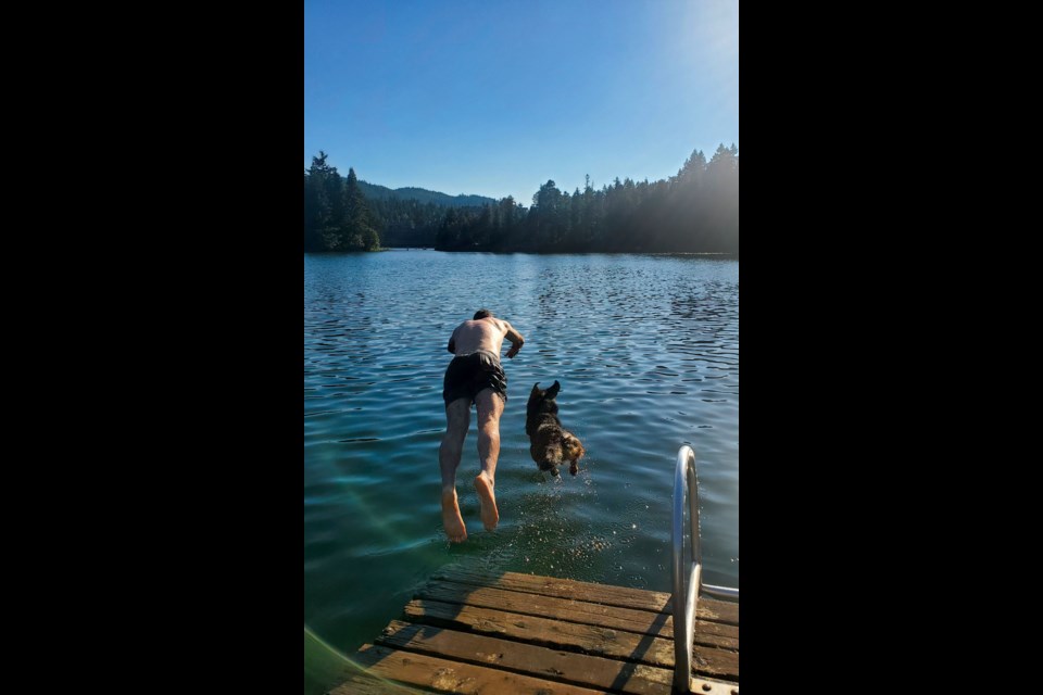 Cormac (left) and Bennitt cool off with a dip at Alpha Lake’s dog dock on Monday night, July 25. 