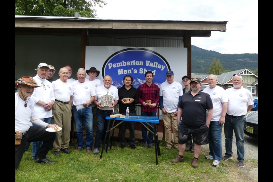 SHED HEADS Members of the Pemberton Valley Men’s Shed pose for a photo with Robert Goluch, president of the Men’s Sheds of Canada (centre left) and MP Patrick Weiler (centre right) at their open house held May 4. 