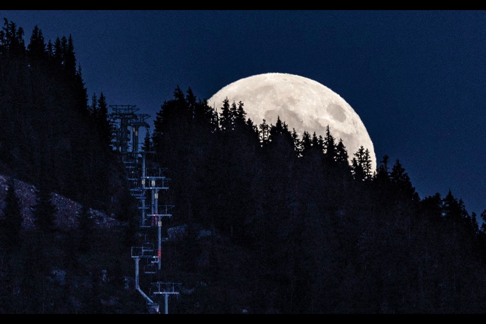 GOOD MOON RISING A bright, full moon rises over Whistler Blackcomb’s Red Chair on Tuesday, June 22.