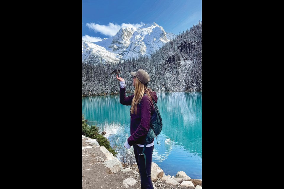 BIRD’S EYE VIEW Jesslyn Gates chats with a Whisky Jack during an unseasonably sunny trip to Joffre Lakes Provincial Park on Thursday, Oct.7. 