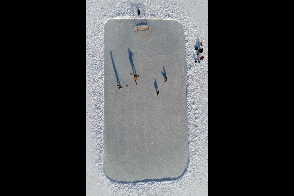 CLASSIC CANADIANS “Lake days” take on a new meaning when temperatures drop in the Sea to Sky. Pictured is a game of pickup on Gates Lake in Birken on Feb. 15.