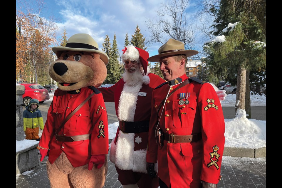 DONATION STATION Safety Bear, Santa and Whistler RCMP Reserve Cst. Steve LeClair at the RCMP’s annual Holiday Toy and Food Drive on Dec. 15 in front of Fresh Street Market. Police joined forces with the local fire department, the municipality, and BC Ambulance to pack a cruiser full of toys and food for the Whistler Community Services Society. 