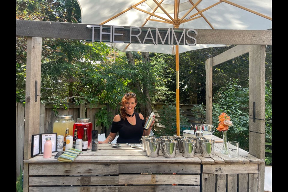 PURE TALENT Nancy Knapton is a woman of many talents. Here she is bartending a beautiful backyard wedding in Creekside on Saturday, July 8 after styling the hair of some of the guests. 