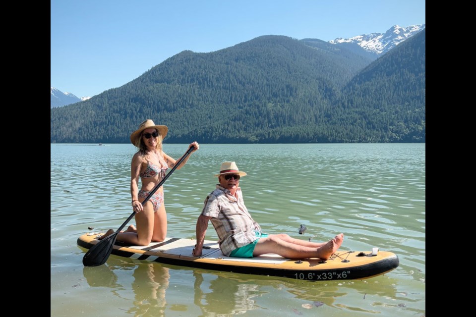 NEW TRICKS Helen Hamilton took her father Malcolm out for a paddleboard ride on Lillooet Lake as the temperature spiked last week. Visiting from the United Kingdom, Malcolm learned how to float at age 88. 
