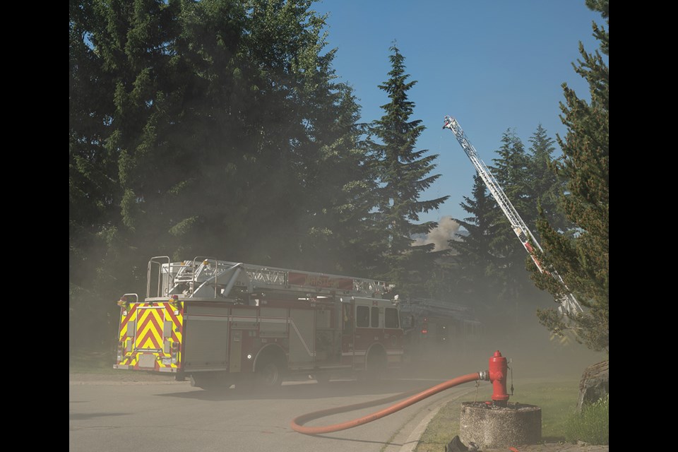 A house fire with flames burning though the roof.  Falcon Crescent in the Blueberry Hills neighbourhood in Whistler.

David Buzzard Photography
dbuzzard@mac.com
www.media-centre.ca