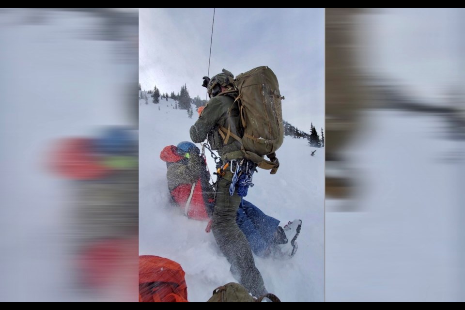 A member of B.C. RCMP's Air Services team conducts the hoist rescue of an injured backcountry skier near Pemberton on March 29. It is believed to be the RCMP's first civilian hoist rescue. 