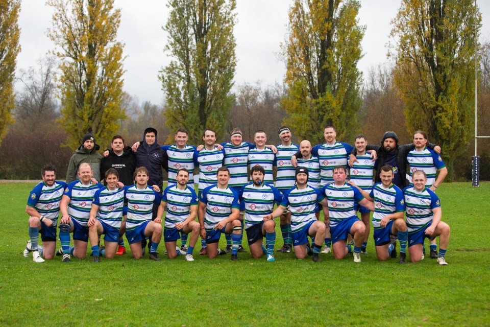 Members of the Axemen Rugby Club pose for a group photo.  