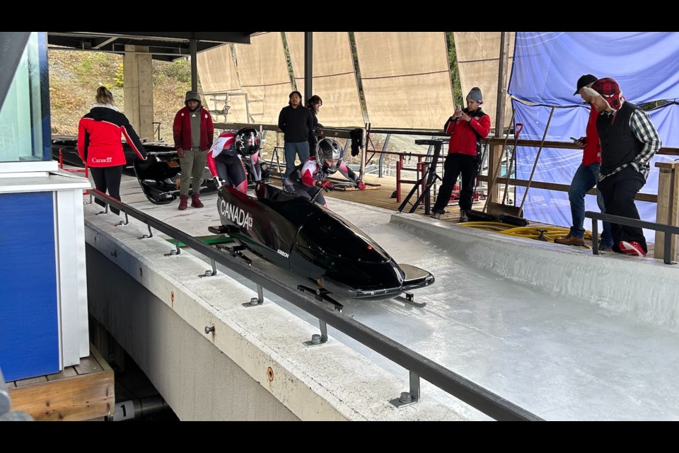 Two Canadian bobsledders prepare to launch at the Whistler Sliding Centre on Nov. 3 for BCS selection races.