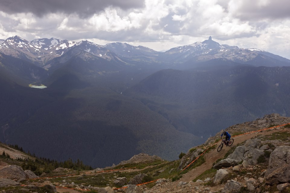 Brittany Phelan navigates a lengthy trail against a mountainous backdrop at the 2023 Canadian Open Enduro.