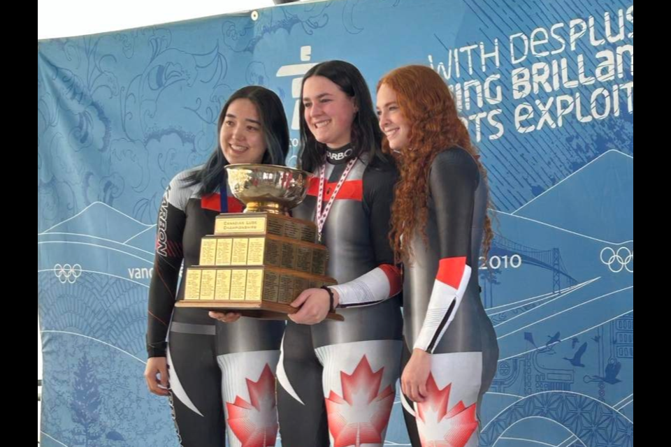 Embyr-Lee Susko (centre) stands on the podium with Midori Holland (left) and Kailey Allan after winning the U21 race at the 2023 Canadian Luge Championships. Photo by David Song.