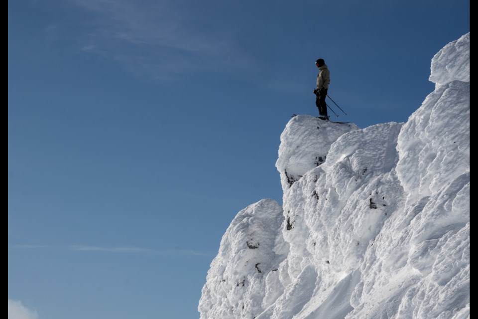 Kane Gascoigne of the Whistler Freeride Club stands atop an icy outcropping.