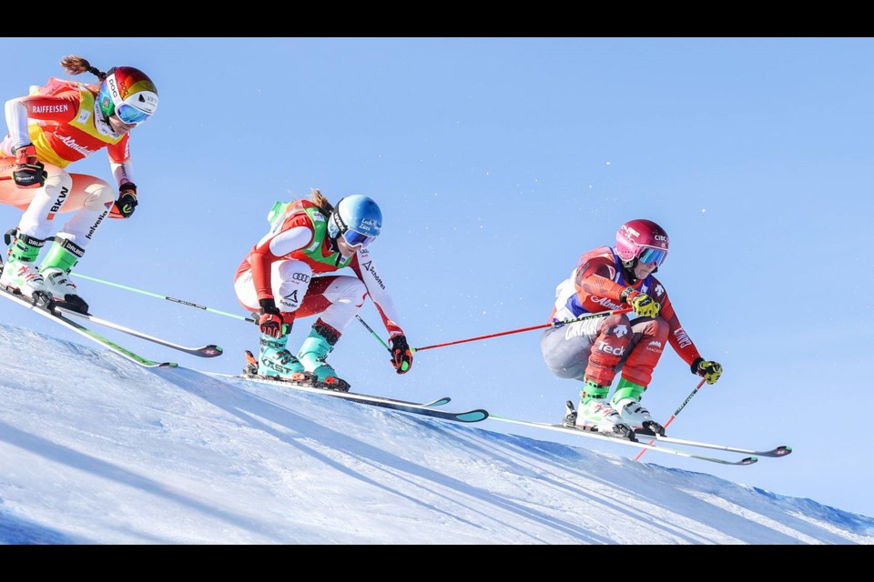 Marielle Thompson (right) flies over a hill during the FIS World Cup ski cross race in Austria on Feb. 16, 2023. 