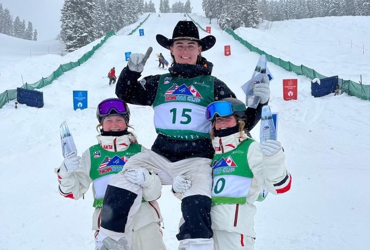 Maya Mikkelsen (right) and Jessie Linton (left) hoist up Cole Carey after the FIS Nor-Am Cup moguls event in Deer Valley on Feb. 8, 2024. 