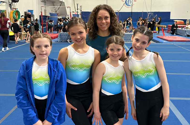 Whistler Gymnastics coach Tami Mitchell (middle) with four of her Xcel Silver athletes. 