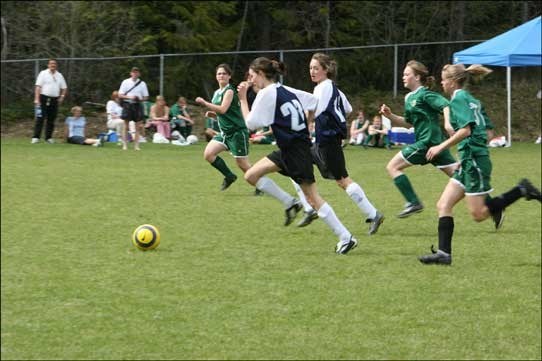 Charmaine Niewerth (23) and Melissa Smith, Whistler Secondary girls soccer team, head off Pender Harbour for the ball in the season opener, Friday, March 5. Whistler defeated Pender Harbour 1-0 with a goal by Tori Jenkins. The team, comprised of grades eight to 12 students, also defeated Xit'olacw (Mount Currie) 2-0, Monday, but then lost to Squamish's Don Ross 3-0 Tuesday. Photo by Maureen Provencal