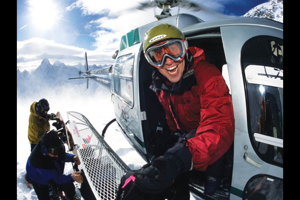 A happy skier exits the helicopter, ready to embark on an adventure of a lifetime. photo by Eric Berger