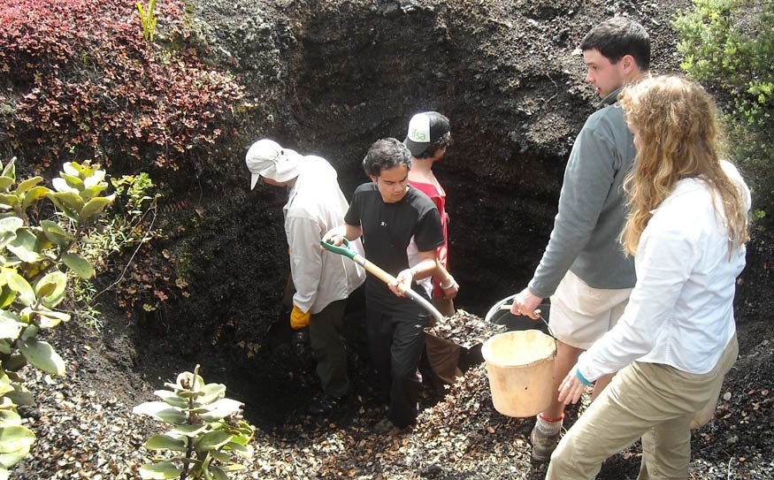 Quest University volcanology students Toby Freyer, Lucas Nguyen, Ben Kelley and Havilland Day dug a pit to find a layer of Hawaiian rock created bin 1959 with Wendy Stovall from the U.S. Geological Survey Volcano Hazards Team.