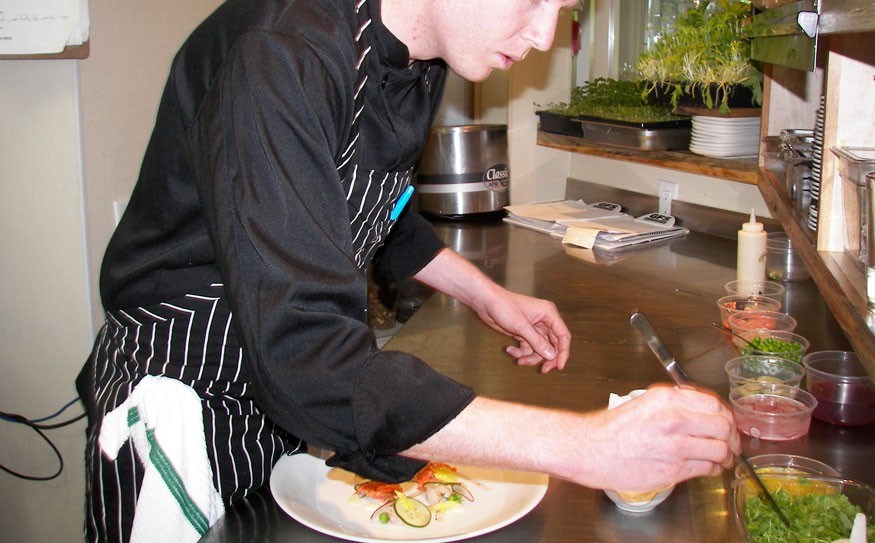 Chef Nicholas Cassettari of Alta Bistro with a salmon and prawn salad featuring English peas, celery leaves, radishes, cucumber and homemade mayonnaise. Photo by John French