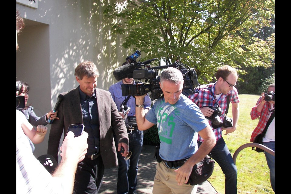 NO COMMENT Robert Fawcett (brown jacket) left the North Vancouver Courthouse through a side door more than an hour after his hearing concluded Thursday Aug.30. By John French