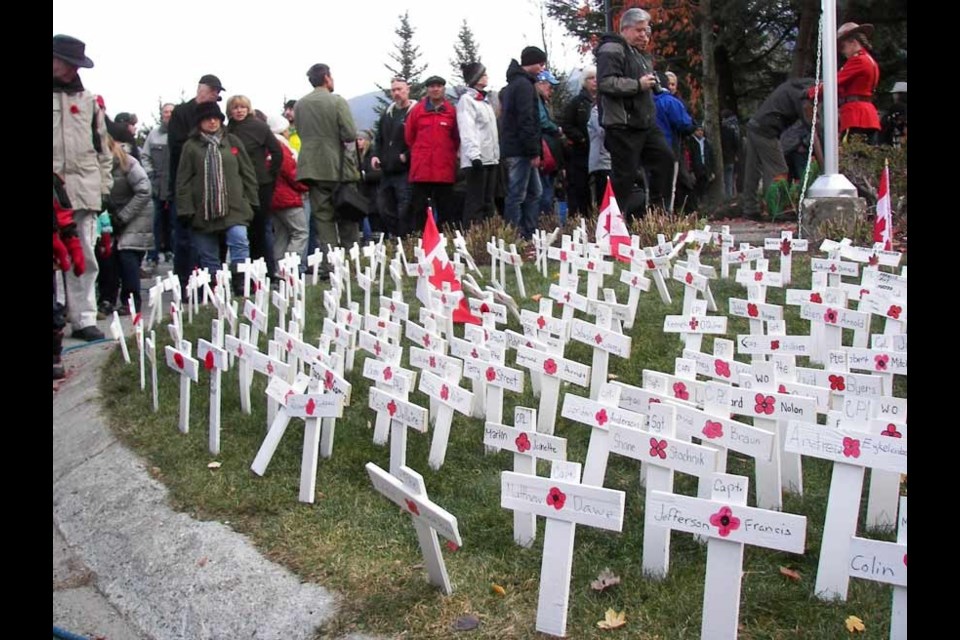 COMMEMORATIVE CROSSES Whistler businesses donated materials and young Whistler residents helped Whistler firefighters create crosses and place names of fallen soldiers on the crosses for Remembrance Day. Photo by John French