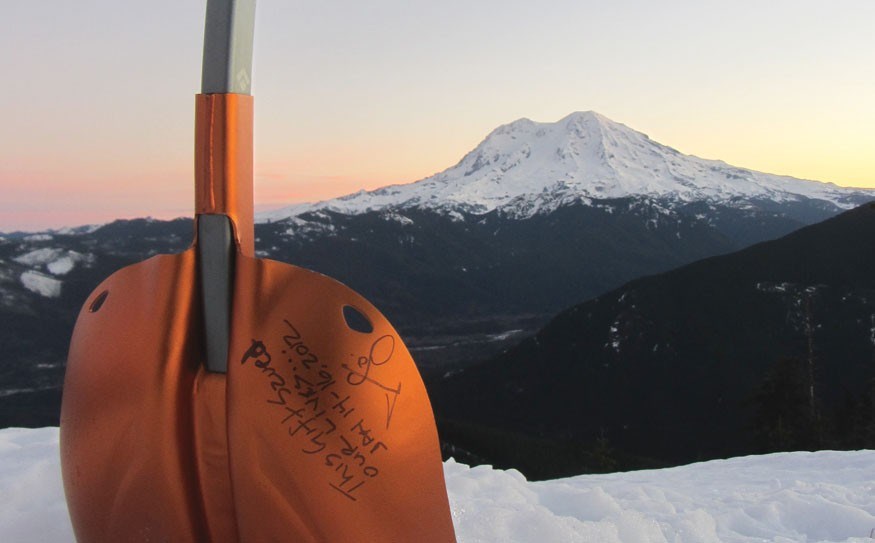 Jo Johnson and Jim Dickman's trusty shovel which was used to dig their snow caves on Rainier during their ordeal. They signed it the weekend they survived and it has joined them on every expedition since.