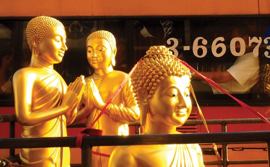 Golden statues decorate the streets of Bangkok; photo by Steve Burgess.