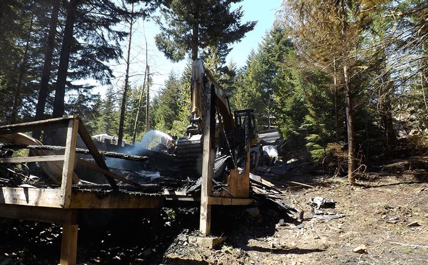 ONE LESS HOME A house on Mountainview Drive had to be pulled apart by an excavator after it was completely destroyed by fire early in the morning of Saturday, May 4. Photo by John French