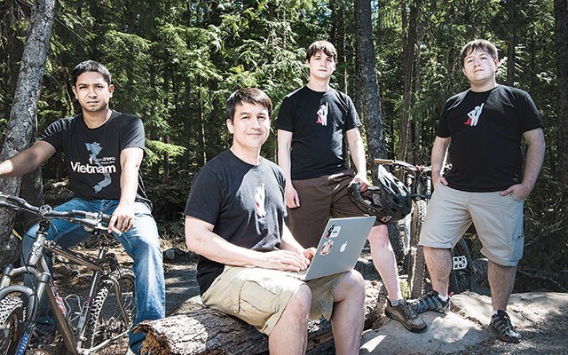 Michael Stephenson, centre left, and staff of Payroll Hero take to the woods with mountain bikes and laptops. Photo by Adam Blasberg.  <a href="http://www.adamblasberg.com/">www.adamblasberg.com</a>