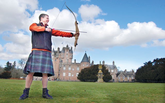 Ross Boardman of Boots N Paddles teaches archery on the front lawn of Glamis Castle (the childhood home of the late Queen Mother) as part of Adventures by Disney's A Brave Adventure tour of Scotland. Photo By Steve MacNaull