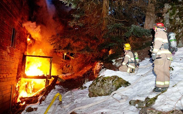 NO WATER Whistler fire fighters look on helplessly as a home on Emerald Drive burns. The closest fire hydrants were frozen and fire fighters couldn't get water to their hoses. Photo by David Buzzard / www.davidbuzzard.com