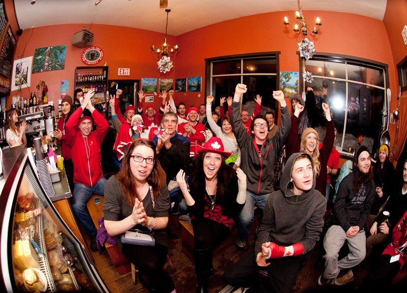 HOCKEY GOLD: Fans cheer on Canada at Alpine Cafe as the team takes gold. Photo by Dave Buzzard/www.davidbuzzard.com