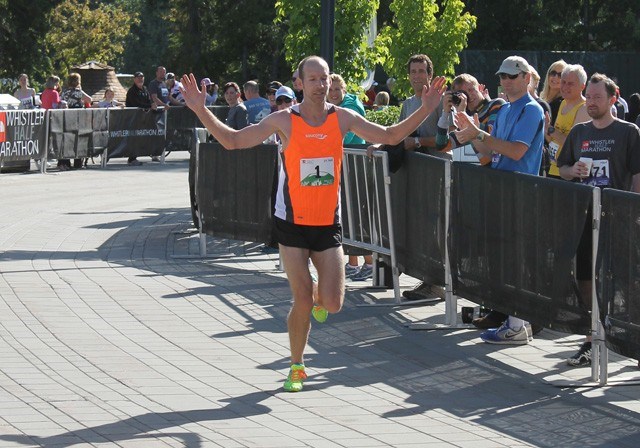 Abbotsford's David Jackson celebrates as he arrives at the finish line in first place, winning The North Face Whistler Half Marathon for the second year in a row. Photo by Eric MacKenzie