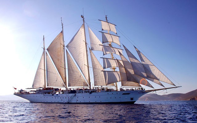 The 360-foot, 16-sail Star Clipper looks regal sailing the Aegean Sea just off the coast of the Greek island of Patmos. Photo by Steve MacNaull