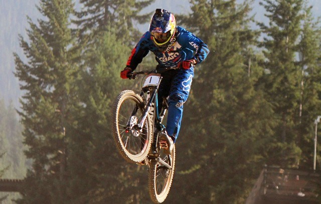 Marcelo Gutierrez Villegas soars over the final jump of the Canadian Open DH course. The Colombian rider won the race and the King of Crankworx title. Photo by Eric MacKenzie