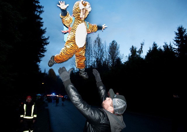 THE WONDERFUL THING ABOUT TIGER: Mike From Montreal tosses his son, Phoenix Rising in the air. Halloween in Whistler's Tapley's Farm neighbourhood. October 31st, 2014. Photo by Dave Buzzard