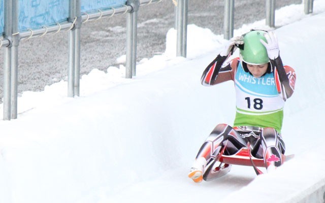 Pemberton's Jenna Spencer grabs her helmet after her first run at Whistler Sliding Centre on Sunday. Photo by Dan Falloon