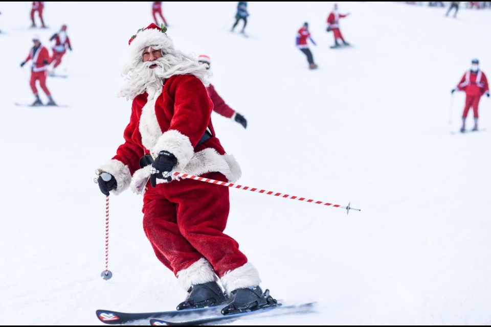 ST. NICK TAKES TO THE SLOPES. Santa Claus visits Whistler to take part in the annual Dress Like Santa Day, Dec. 13. Photo By Patrick Hui courtesy of Whistler Blackcomb