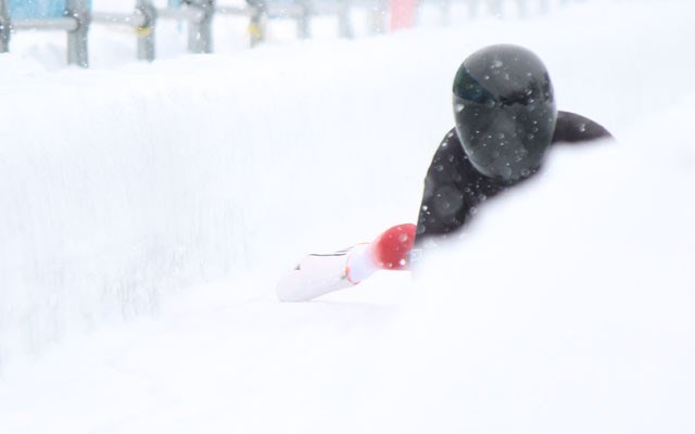 Canadian skeleton racer Jaclyn LaBerge emerges from the snow as she completes her second run in Intercontinental Cup action at Whistler Sliding Centre on Saturday. LaBerge won gold. Photo by Dan Falloon